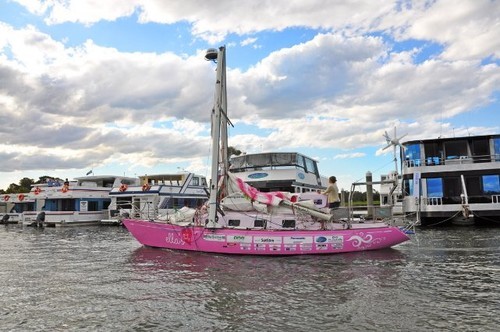 Battered, but unbowed, ’Ella’s Pink Lady’, Jessica standing in the cockpit, approaching the safe haven of the Gold Coast City Marina. - Jessica Watson © Gold Coast City Marina